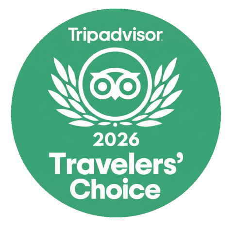 Green round badge with 'Tripadvisor 2026 Travelers' Choice' and owl logo.