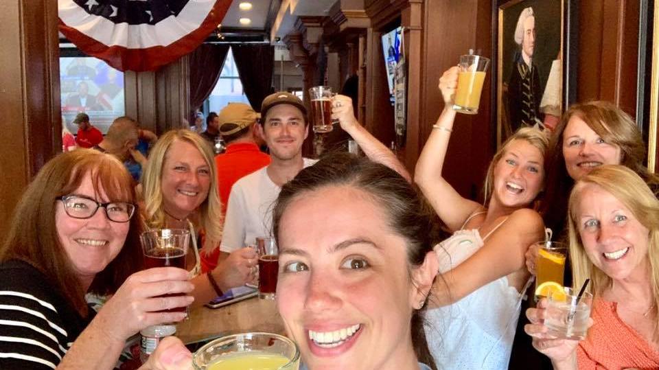 Lexie American Flag a group of people are drinking from a wine glass posing for the camera