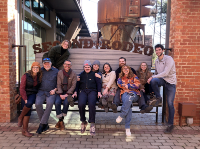 a group of people standing in front of a brick building